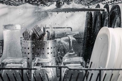 Transparent And Black And White Dishes As Well As Cutlery